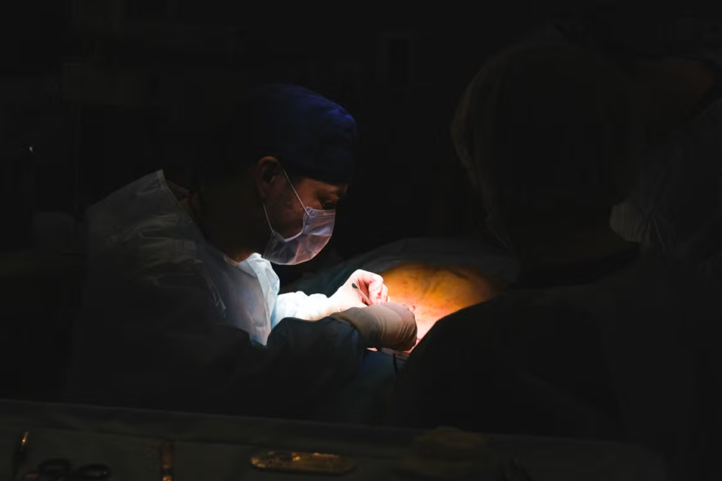 surgeon with surgical mask operating patient