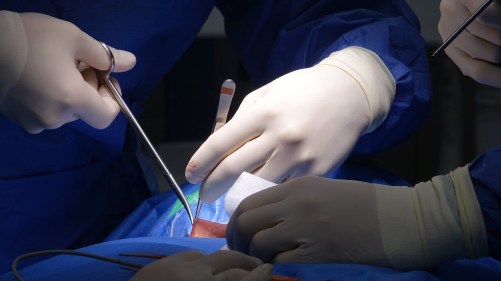 surgeons performing spinal surgery in operating room