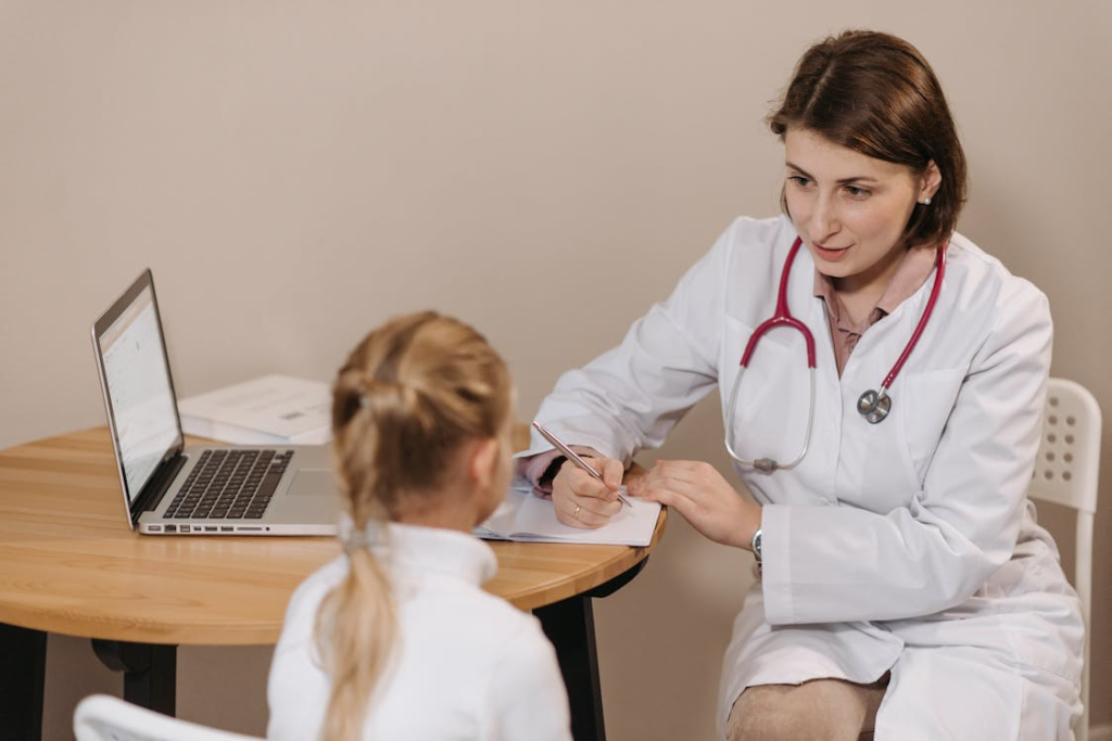 Doctor Listening to a Girl and Writing Down Notes